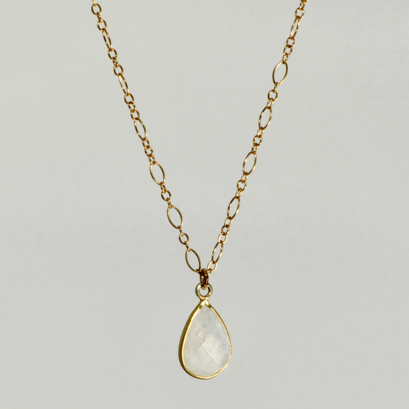 Faceted moonstone teardrop in gold-filled bezel on figaro chain, front view
