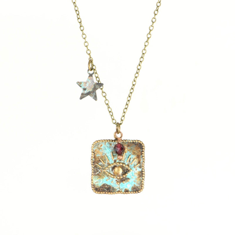 Brass evil eye pendant necklace with garnet and star charm, full length view.