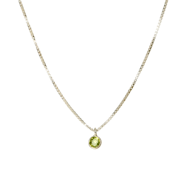 Tiny peridot pendant on sterling silver chain, front view