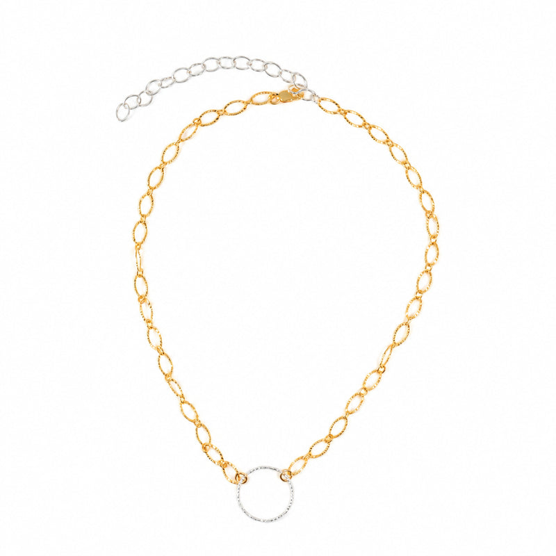 Sterling silver circle choker on gold-filled chain laid flat, showing extender