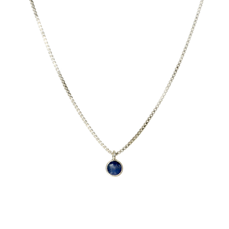 Tiny blue sapphire pendant on sterling silver box chain, front view