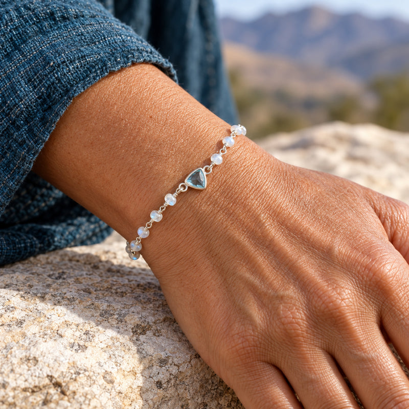 Aqua blue topaz and moonstone sterling silver bracelet worn on the wrist