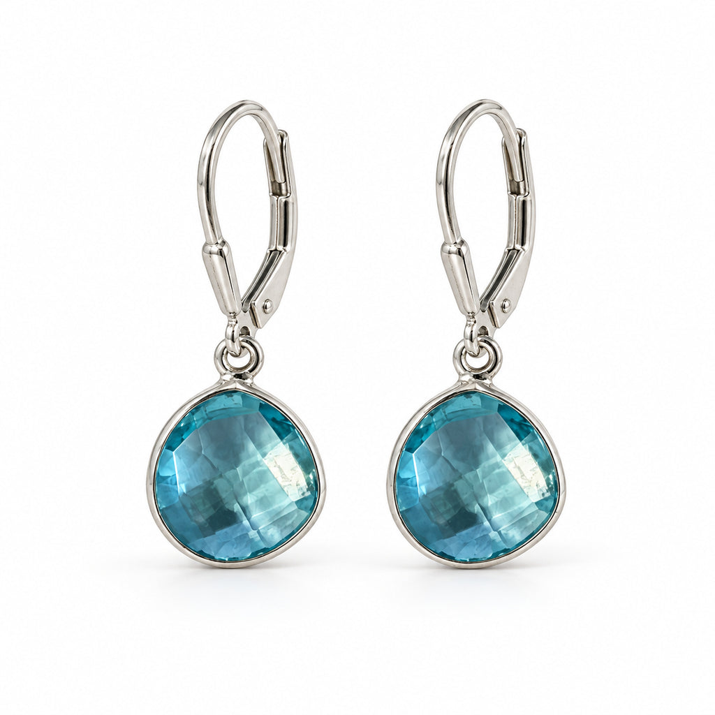 Woman wearing blue topaz pear sterling silver leverback earrings