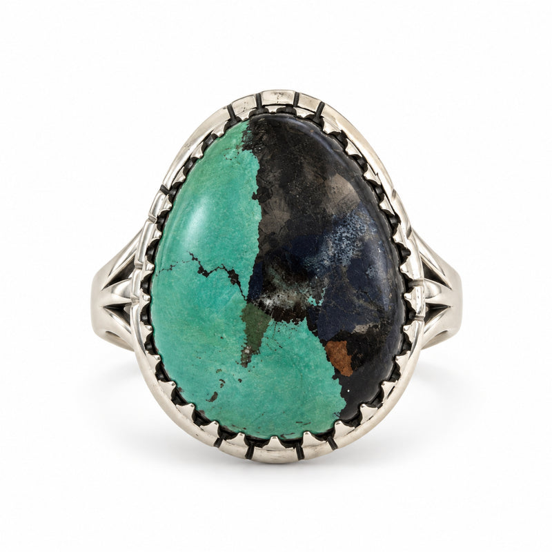 Green turquoise oval ring with black matrix in a sawtooth sterling silver bezel, front product view.