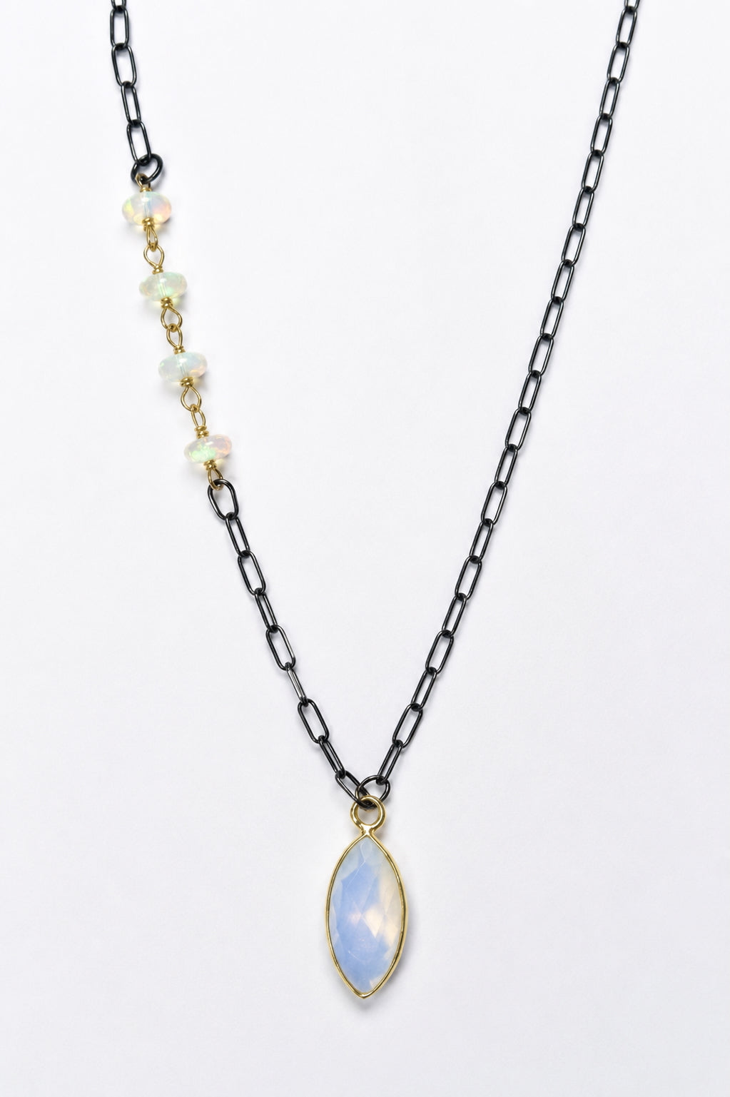 Woman wearing Ethiopian opal beads and opalite pendant on oxidized sterling silver chain with gold vermeil bezel