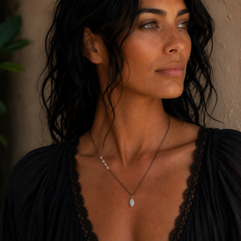 Woman wearing Ethiopian opal beads and opalite pendant on oxidized sterling silver chain with gold vermeil bezel