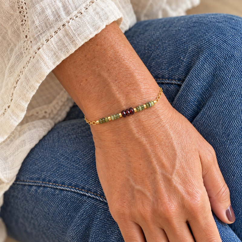 Woman wearing the red and green garnet gold-filled beaded chain bracelet