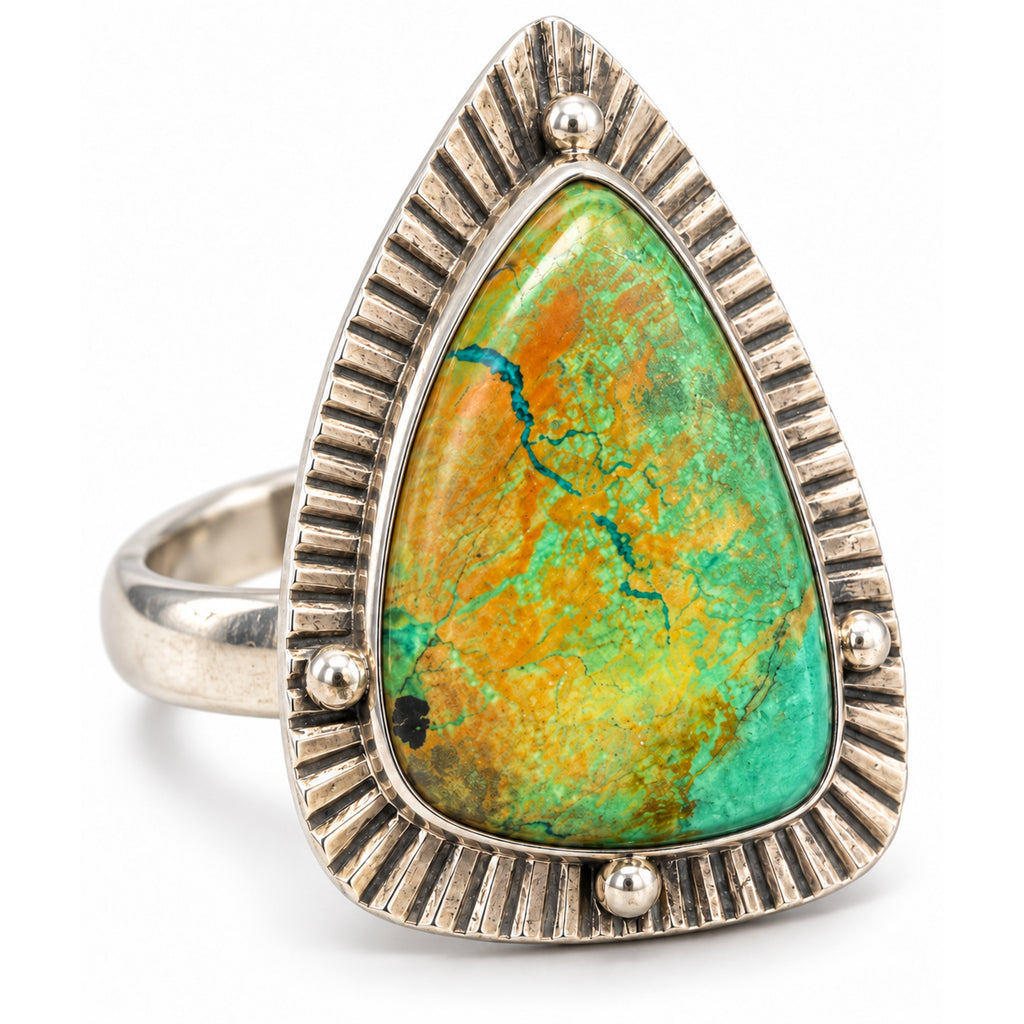 Green and ochre turquoise shield ring in a stamped sterling silver frame with four silver dots, front view.