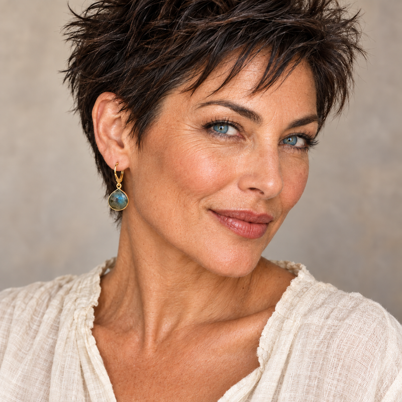 Woman wearing large labradorite pear gold-filled leverback earrings