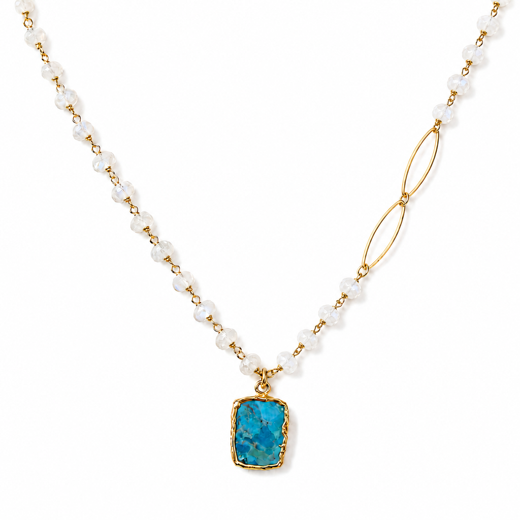 Model wearing an asymmetric natural turquoise and rainbow moonstone necklace with gold-filled chain and marquise links.