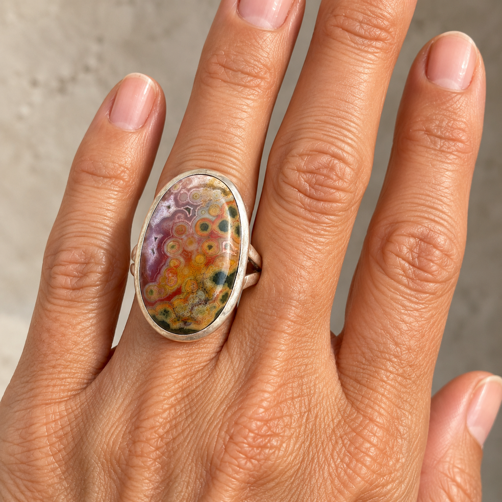 Ocean jasper oval ring in sterling silver bezel, front product view.
