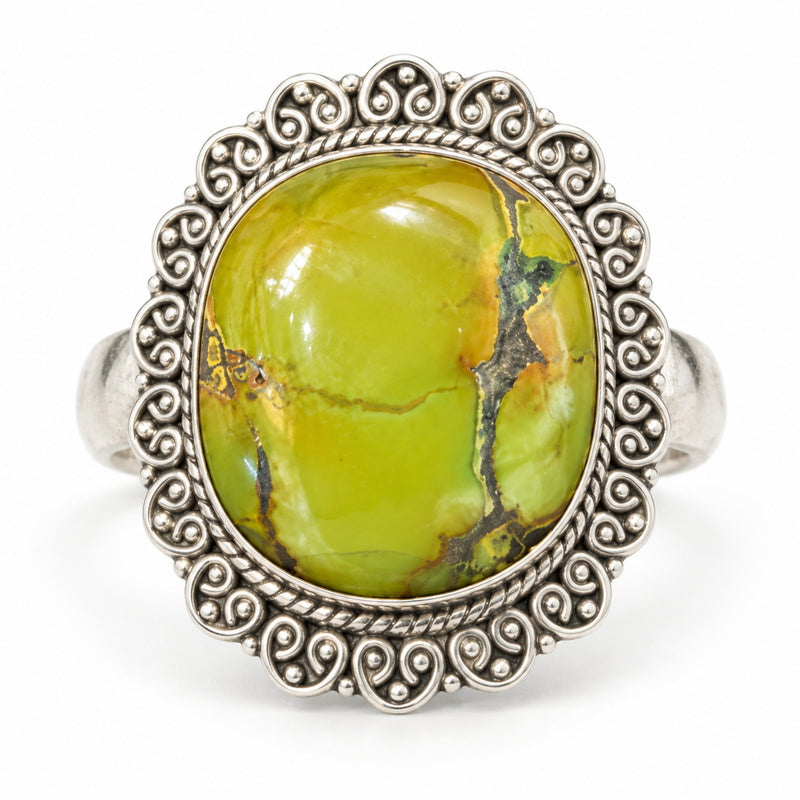 Chartreuse green turquoise ring in a scalloped sterling silver filigree border, front view.