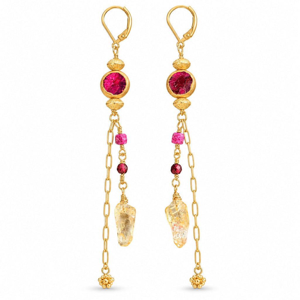 Woman wearing gold-filled long dangle earrings with hot pink turquoise, citrine, ruby, and garnet.