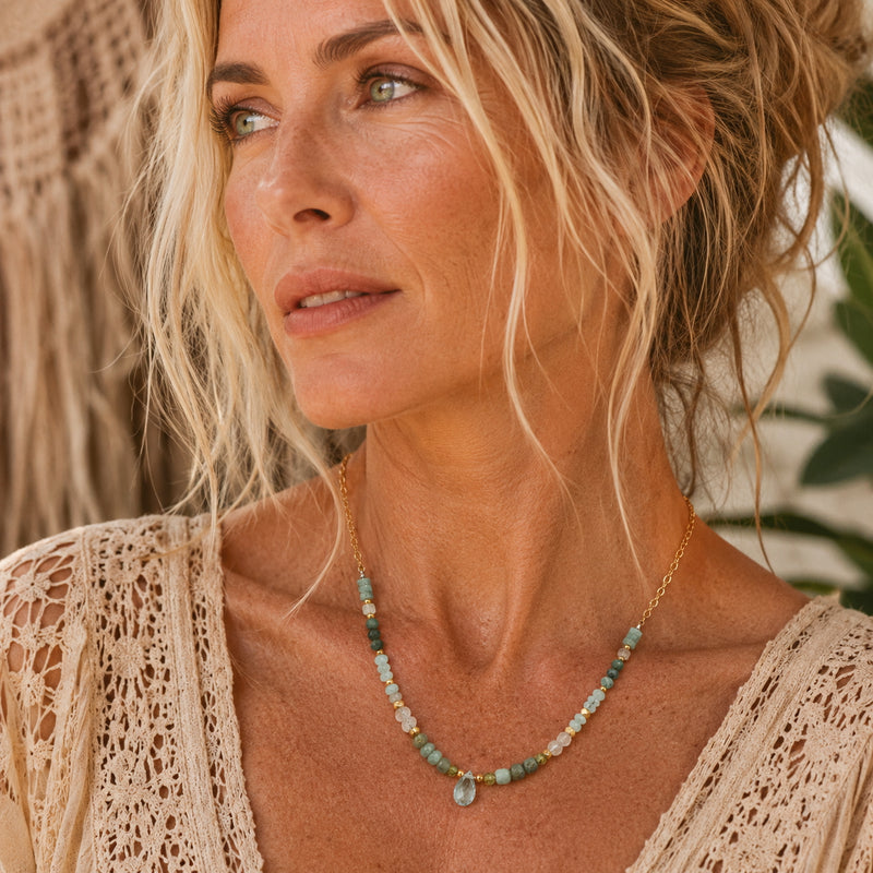 Woman wearing an amazonite, moonstone and aquamarine beaded necklace