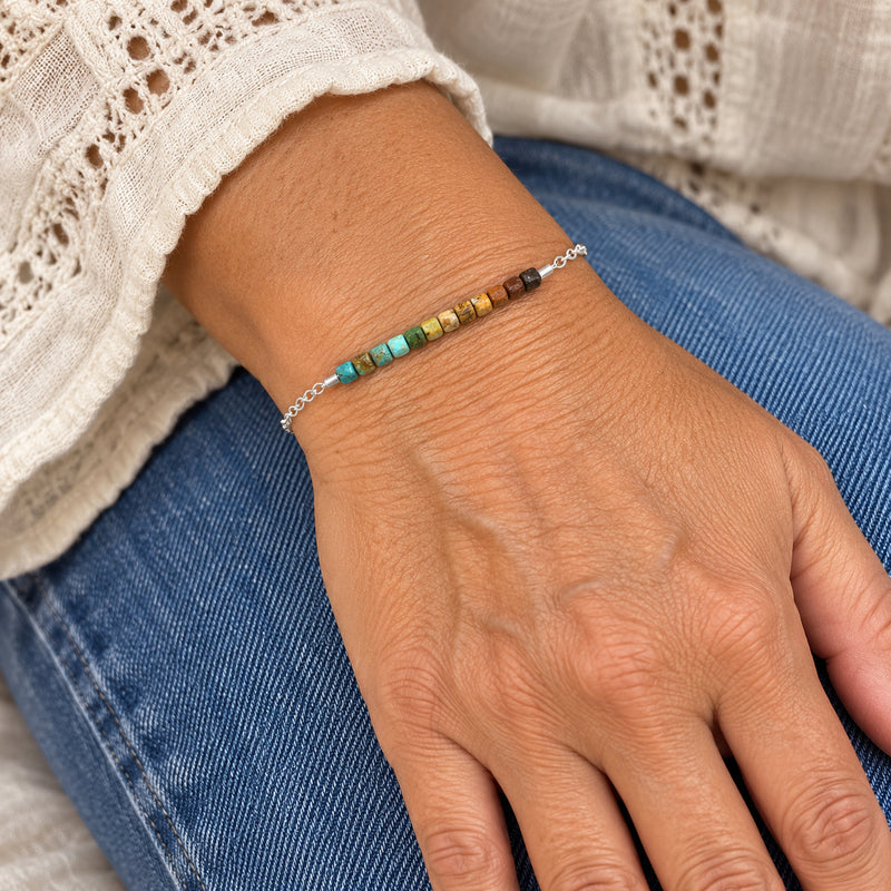 Woman wearing the turquoise gradient cube bead bracelet in sterling silver