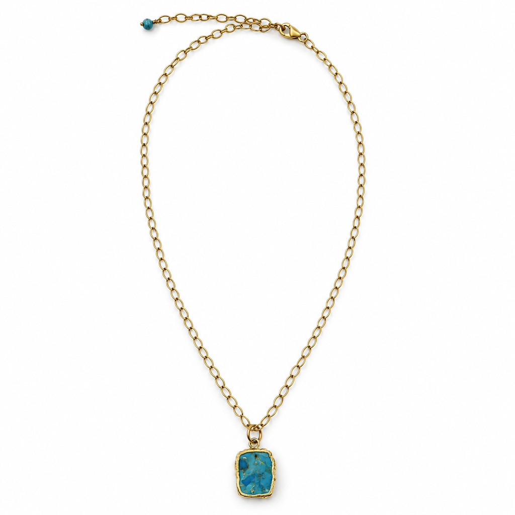 Blonde model wearing a small turquoise pendant necklace with a floral blouse.