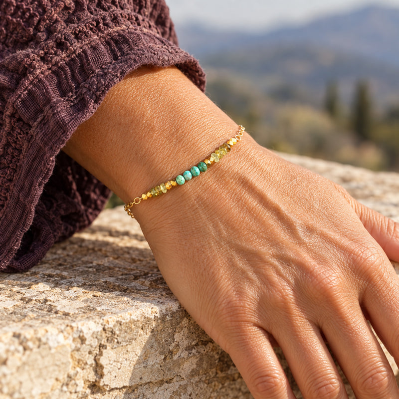 Turquoise and green garnet gold-filled beaded bracelet worn on the wrist